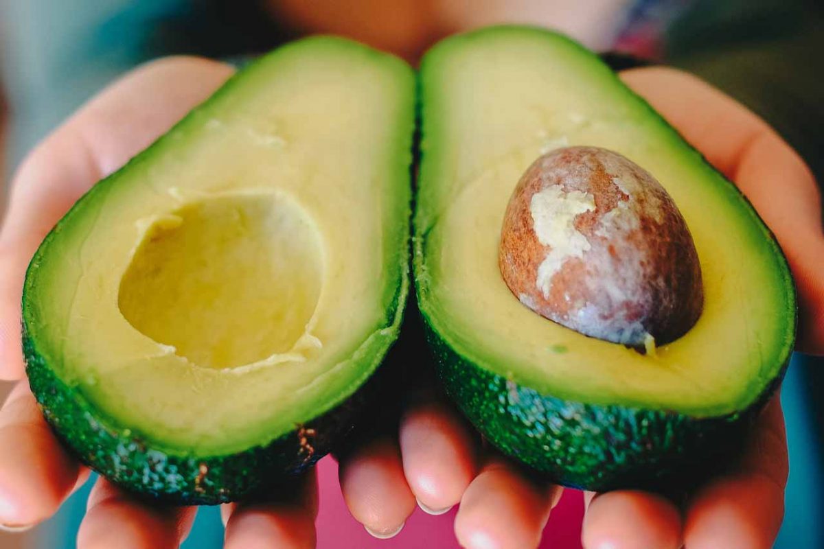 Eating for beauty and beautiful skin - Laura's Idea - avocado in hands
